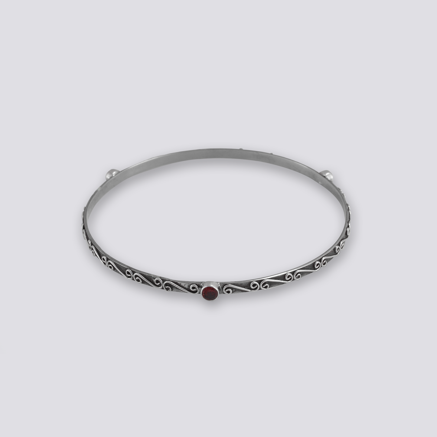 Sterling silver bangle with red garnet