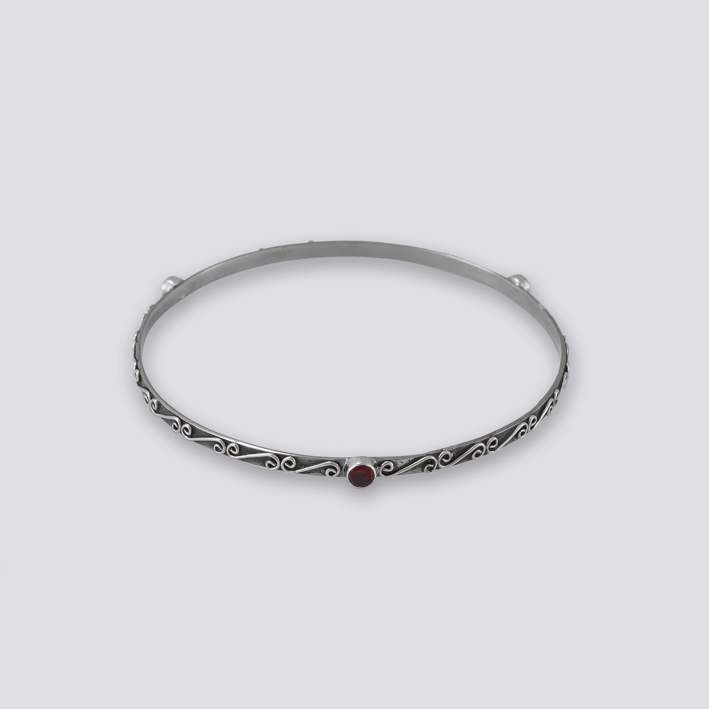 Sterling silver bangle with red garnet